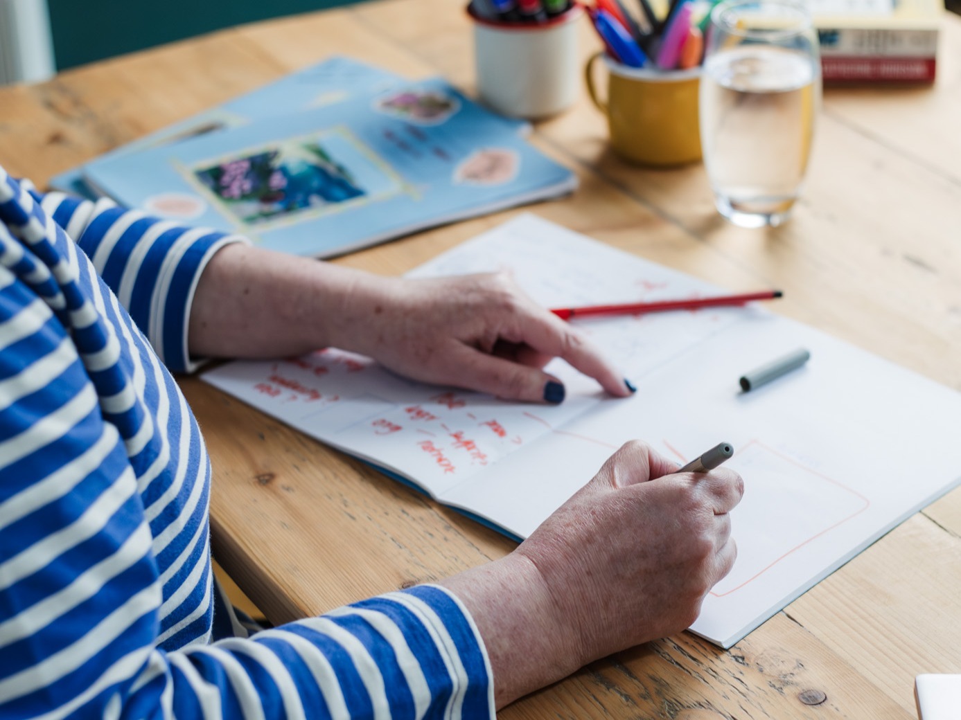 Jane Wilson HR Mentor writing at a desk