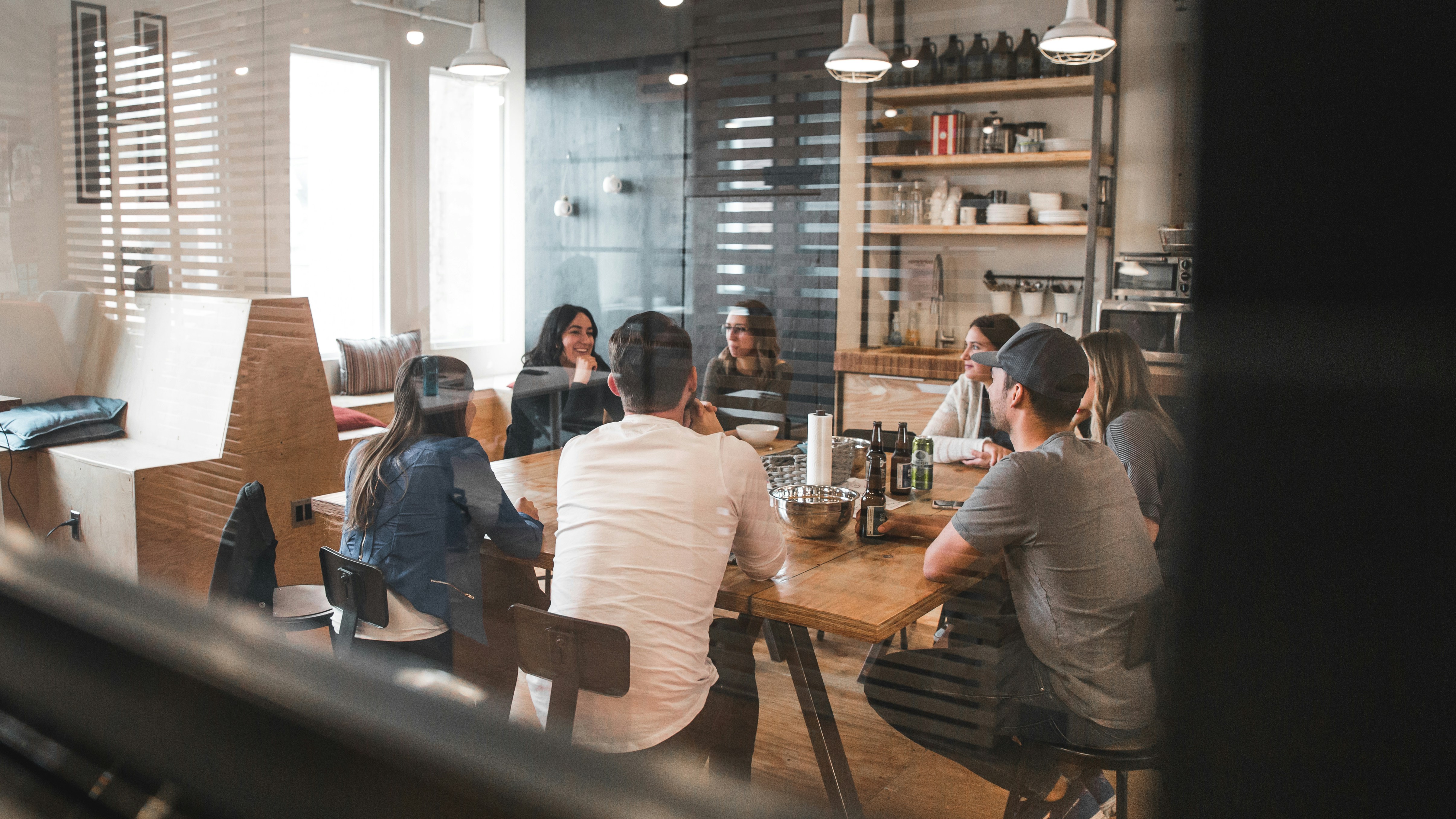 Redd Fransisco photo of team talking in a room from Unsplash