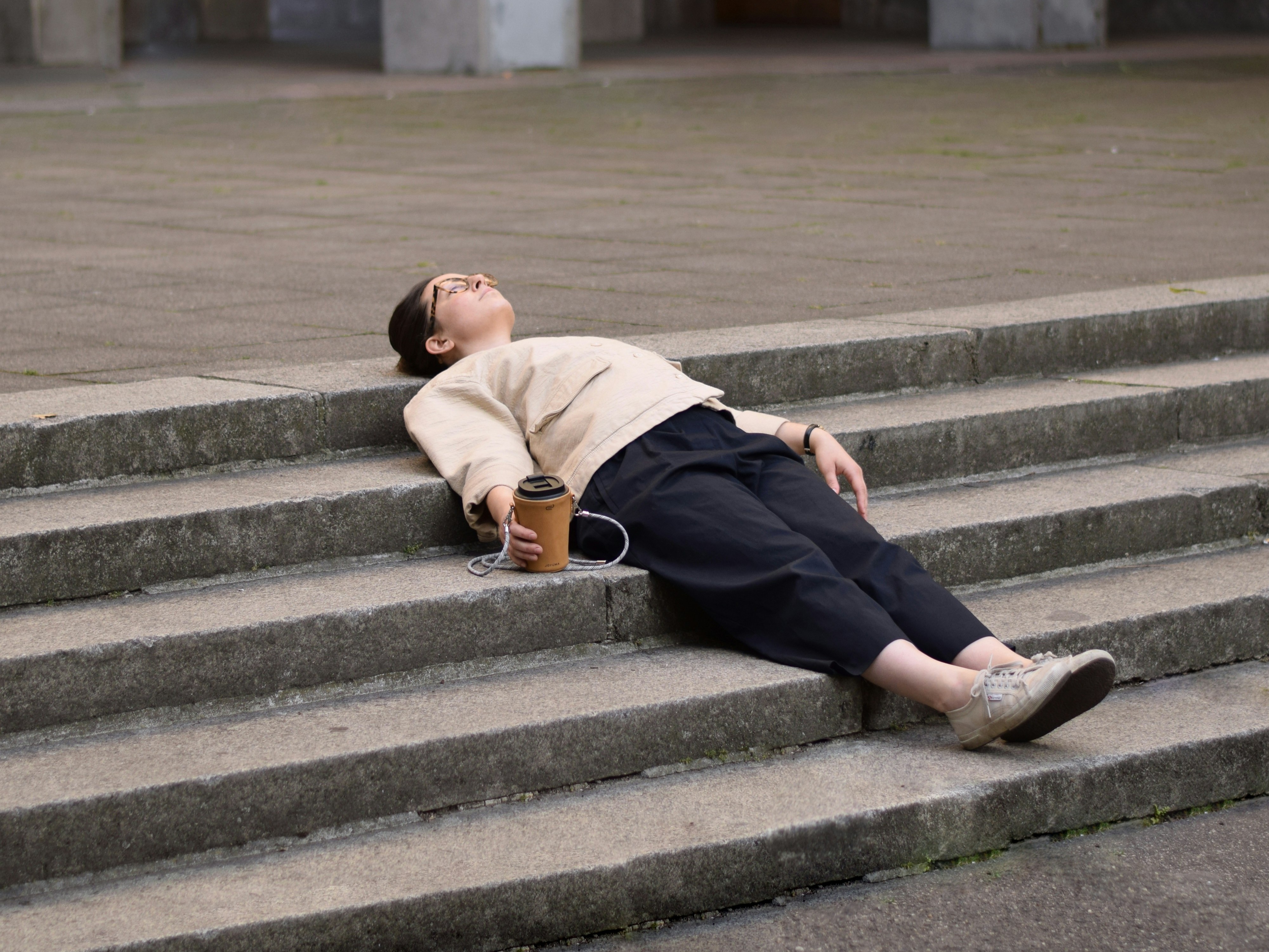 woman lying back on a concrete step